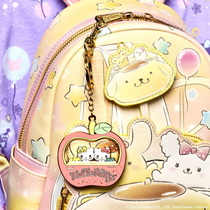 Image of our Hello Kitty Carnival Sliding Keychain attached to the Pompompurin Carnival Mini Backpack 